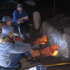 Volunteers keeping the tile kiln fire stoked late into the night